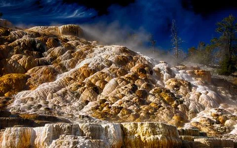 Geothermal Hot Spring Terraces in Dramatic Mountain Landscape Stock Photos