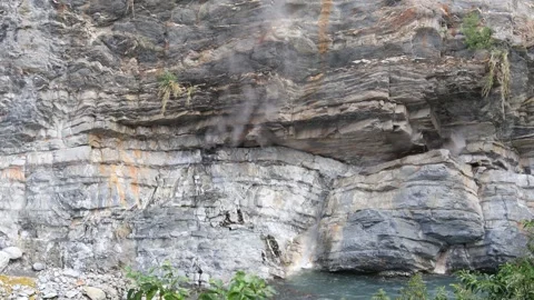 Geothermal smoke and hot spring water erupt from the canyon cliffs. Stock Footage 278281027