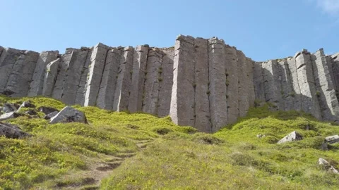Gerduberg basalt column cliff above a green slope, Iceland Stock Footage 346439783