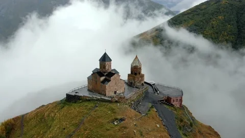 Gergeti Trinity Church in clouds after rain near Village Of Gergeti and Kazbek Stock Footage 237766848