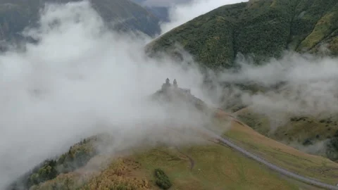 Gergeti Trinity Church in clouds after rain near Village Of Gergeti and Kazbek Vídeo Stock 237767614