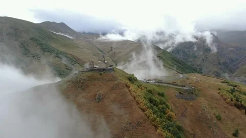 Gergeti Trinity Church in clouds after rain near Village Of Gergeti and Kazbek Stock Footage 237767809