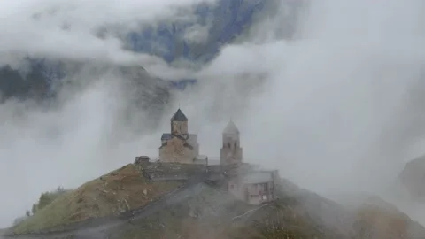 Gergeti Trinity Church in clouds after rain near Village Of Gergeti and Kazbek Stock Footage 237768343