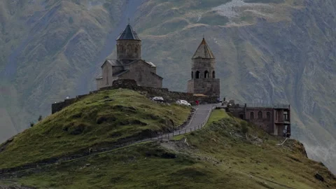 Gergeti Trinity Church on mountain in moving clouds timelapse Stock Footage 292306580