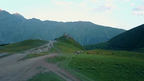 Gergeti Trinity Church, Tsminda Sameba Gergeti Georgia Europe mountains cows Stock-Footage 81379998