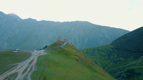 Gergeti Trinity Church, Tsminda Sameba Gergeti Georgia Europe mountains cows Stock-Footage 81380033