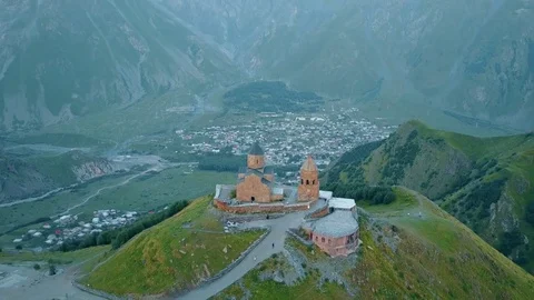 Gergeti Trinity Church, Tsminda Sameba Gergeti Georgia Europe mountains cows Stock Footage 81380054