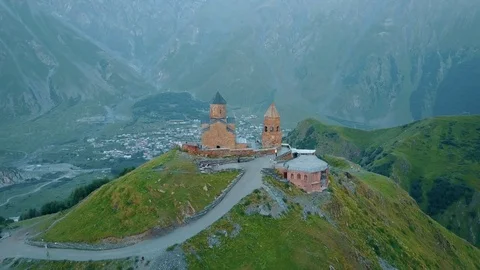 Gergeti Trinity Church, Tsminda Sameba Gergeti Georgia Europe mountains cows Stock-Footage 81380115