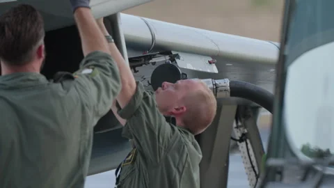 German Air Force technician inspecting aircraft underside Stock Footage 330139006