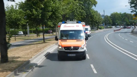 German ambulance driving through the city streets Stock Footage