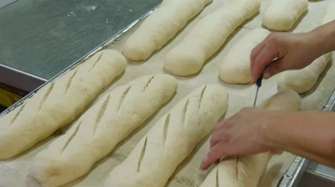 German baker cut many different  bread dough Stock Footage 56517188