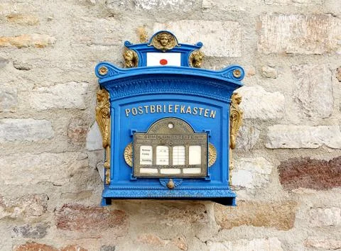 German blue mailbox on the brick wall Stock Photos