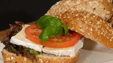 German bread: oak roll bun with camembert tomato on turntable Stock Footage 82648319