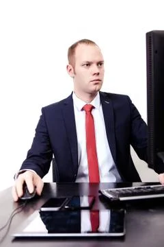 German businessman working in the workplace computer. Phone, tablet, mouse Stockfoto's
