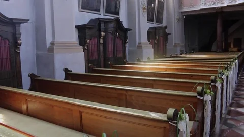 German church catholic empty rows with wedding decoration and sunshine Stock Footage 71204393