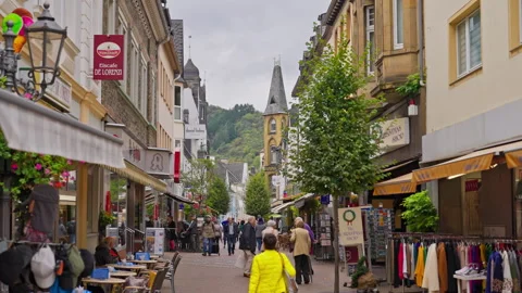 German cobblestone walking street lined with shops and tourists in the old town Stock-Footage 303673892