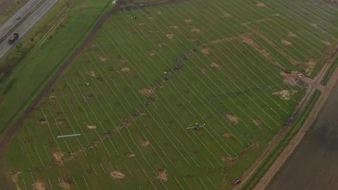 German construction site with workers assembling solar energy systems Stock Footage 320246673