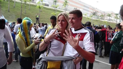 German couple being friendly and give thanks in portuguese in 2014 World Cup Stock Footage 40029171
