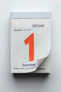 A German daily calendar showing New Year's Day with curled up pcorner Stock Photos