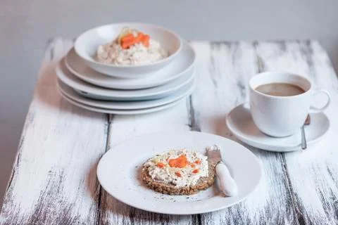 German dark multi-grain bread with cream cheese and carrots, cup of coffee on Stock Photos