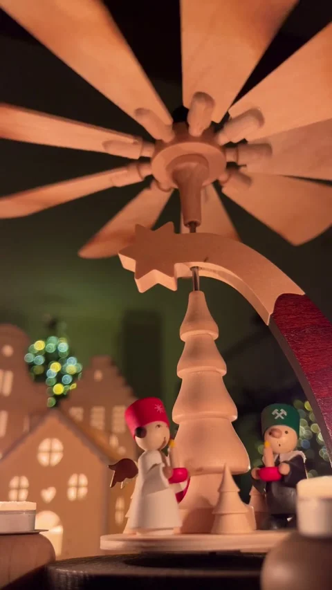German Dutch christmas pyramid rotating above illuminated dutch houses and Stock Footage 311101342