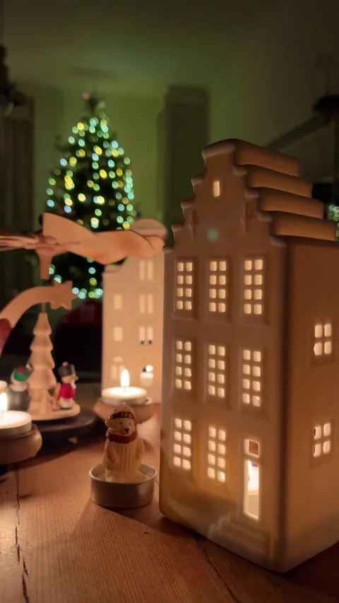 German Dutch christmas pyramid rotating above illuminated dutch houses and Stock Footage 311107237