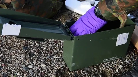German EOD soldier remove explosive materials from ammunition box Stock Footage 97447610