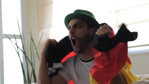 German Fan Celebrating at Home Stock Footage 87177553