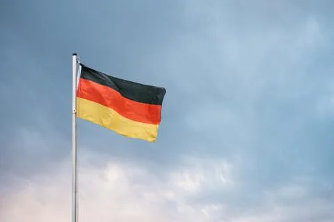 German flag against the backdrop of the setting sun. 스톡 사진