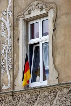 German Flag Displayed in Historic Window of Ornate European Building Facade Stock Photos