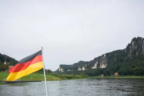 German flag at ferry through the Elbe at Kurort Rathen village and Bastei r.. Stock Photos
