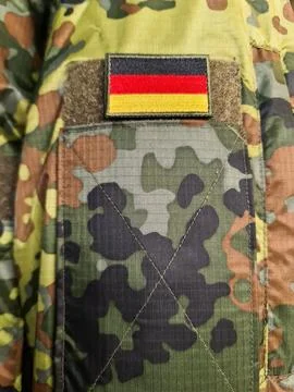 German flag patch on military army camouflage uniform Stock Photos