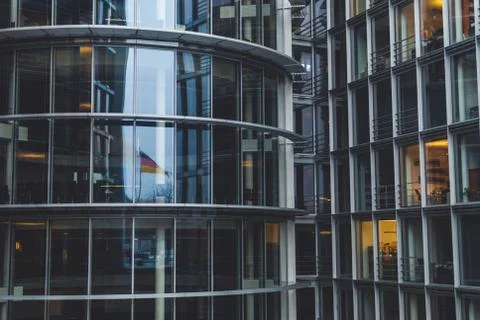 German flag reflected in governmental building. People working in the office  Foto stock