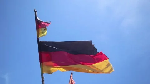 A German flag torn by storm winds Video stock 345704003