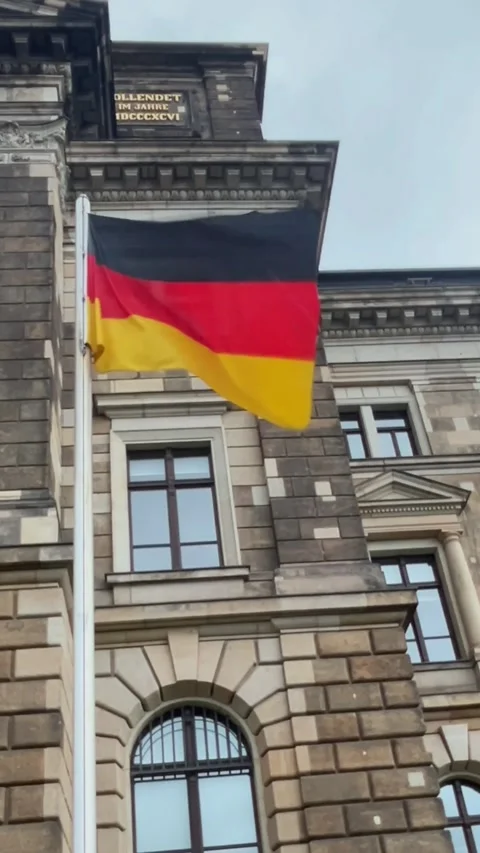 German flag waves proudly in front of historic building in Berlin during ea.. Stock Footage 329320126