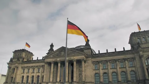 German flag waving against the background of the Reichstag Stock Footage 254361175