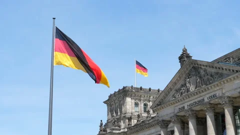 German flag waving in front of Reichstag building facade in Berlin Stock Footage 344298733