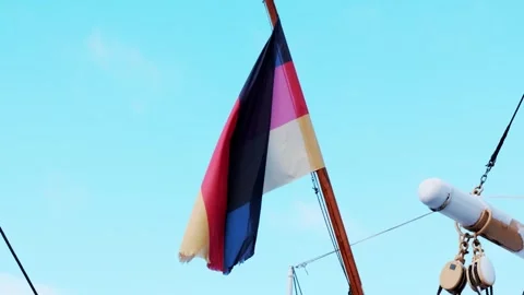 German flag waving gracefully in wind on tall mast of historic sailing ship.. Stock Footage 337755243