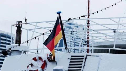 German flag waving on ship mast during cold winter day at river port. Stock Footage 337755057