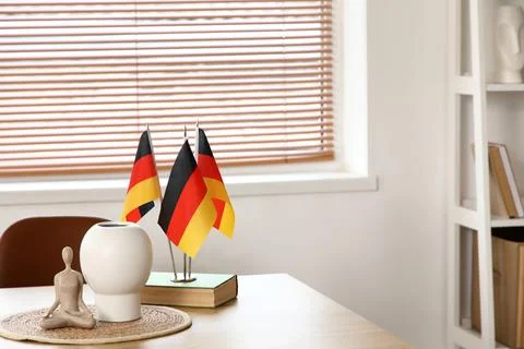 German flags with book and decor on table in room Stock Photos