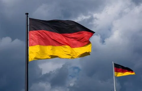 German flags in front of dark cloud Stock Photos