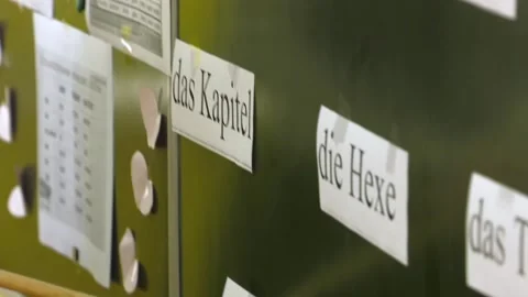 German language class concept. The teacher points to the words with a pointer. Stock Footage 105071327