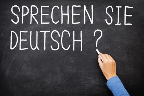 German Learning language teacher in class writing  Sprechen Sie Deutch Stock Photos