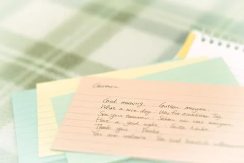 German; Learning New Language Writing Greetings on the Notebook Stock Photos