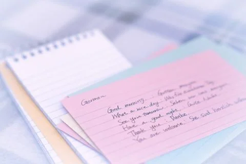 German; Learning New Language Writing Greetings on the Notebook Stock Photos