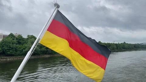 German national flag flying over Danube river Stock Footage 312901353
