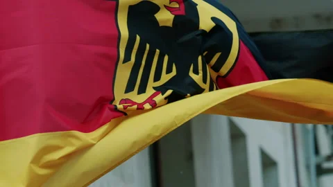 German national flag waving in the wind, showing the black, red, and gold colors Stock Footage 336799813