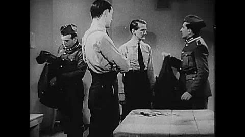A German officer interrogates the navigator of a Royal Air Force warplane and Stockbeeldmateriaal 115544928
