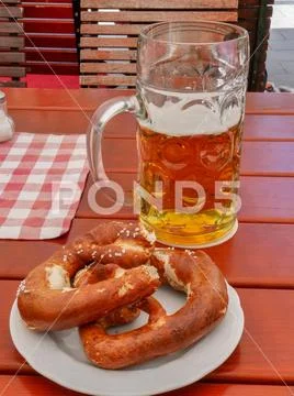 German Oktoberfest style stein glass of beer and salted pretzel, Munich, Germany Stock Photos