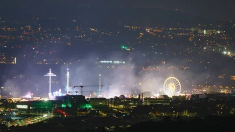 German people's fair in the evening with ferris wheel and illuminated rides Stock Footage 221368268